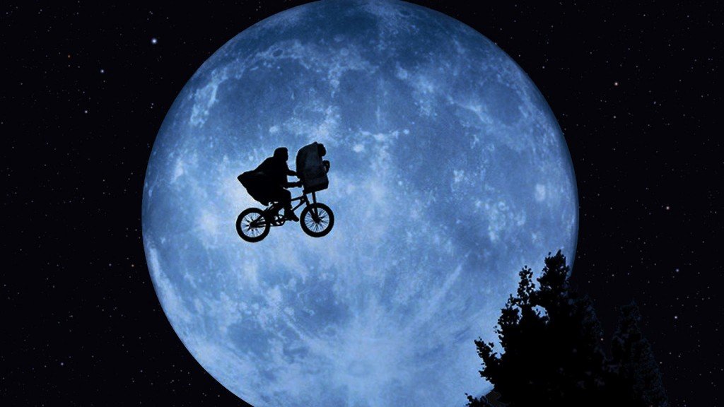 Elliott and E. T. in front of the Moon