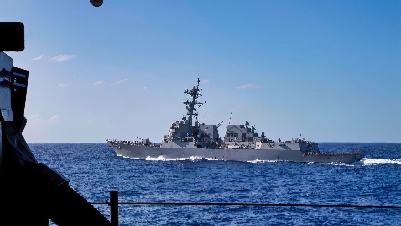 Arleigh Burke-class guided-missile destroyer USS Michael Murphy (DDG 112) sails alongside Nimitz-class aircraft carrier USS Abraham Lincoln (CVN 72) on Dec. 8, 2025. USS Abraham Lincoln (CVN 72), flagship of the Abraham Lincoln Carrier Strike Group, is underway conducting routine operations in the U.S. 7th Fleet area of operations, demonstrating the U.S. Navy’s long-term commitment to a free and open Indo-Pacific. (U.S. Navy photo by Mass Communication Specialist 3rd Class Nathaly Cruz)