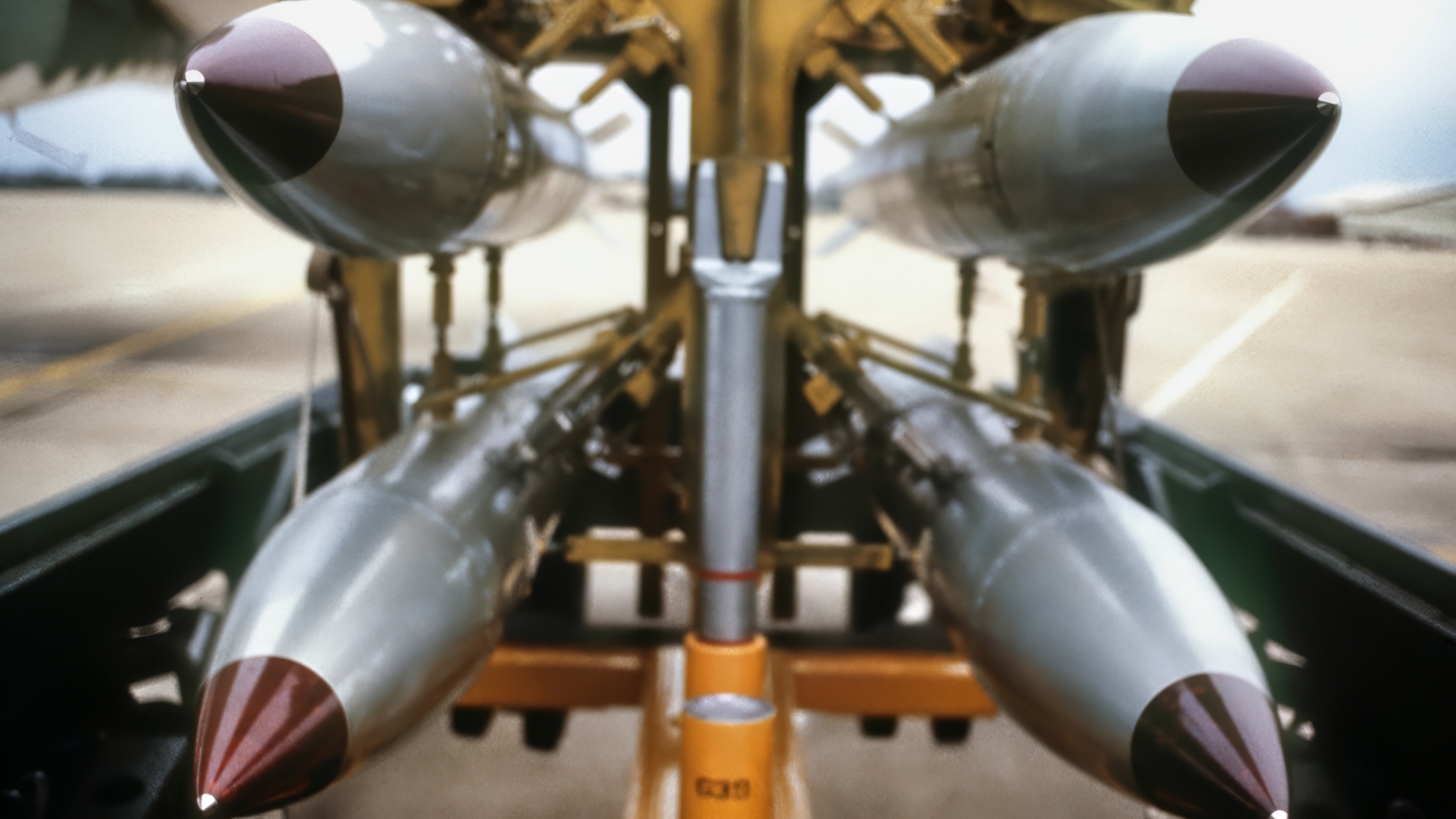 A front view of four nuclear free-fall bombs on a bomb cart. Image Credit: Creative Commons.