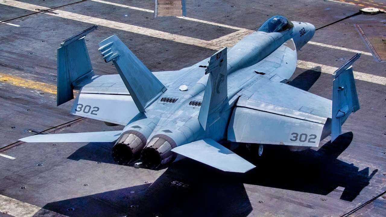 A Sailor directs an F/A-18E Super Hornet from the “Kestrels” of Strike Fighter Squadron (VFA) 137 on the flight deck of the aircraft carrier USS Nimitz (CVN 68) in the South China Sea, May 12, 2025. Nimitz is underway in the U.S. 7th Fleet area of operations on a scheduled deployment, demonstrating the U.S. Navy's unwavering commitment to a free and open Indo-Pacific. (U.S. Navy Photo by Mass Communication Specialist Seaman Apprentice Franklyn M. Guage)
