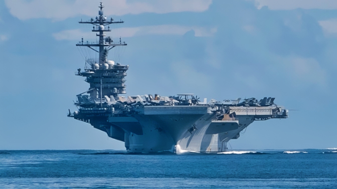 SIBUTU PASSAGE (Feb. 6, 2025) – The Nimitz-class aircraft carrier USS Carl Vinson (CVN 70), left, and the Ticonderoga-class guided-missile cruiser USS Princeton (CG 59) transit the Sibutu Passage Feb. 6, 2025. The Carl Vinson Carrier Strike Group is underway conducting routine operations in the U.S. 7th Fleet area of operations. (U.S. Navy photo by Mass Communication Specialist 3rd Class Brianna Walker)