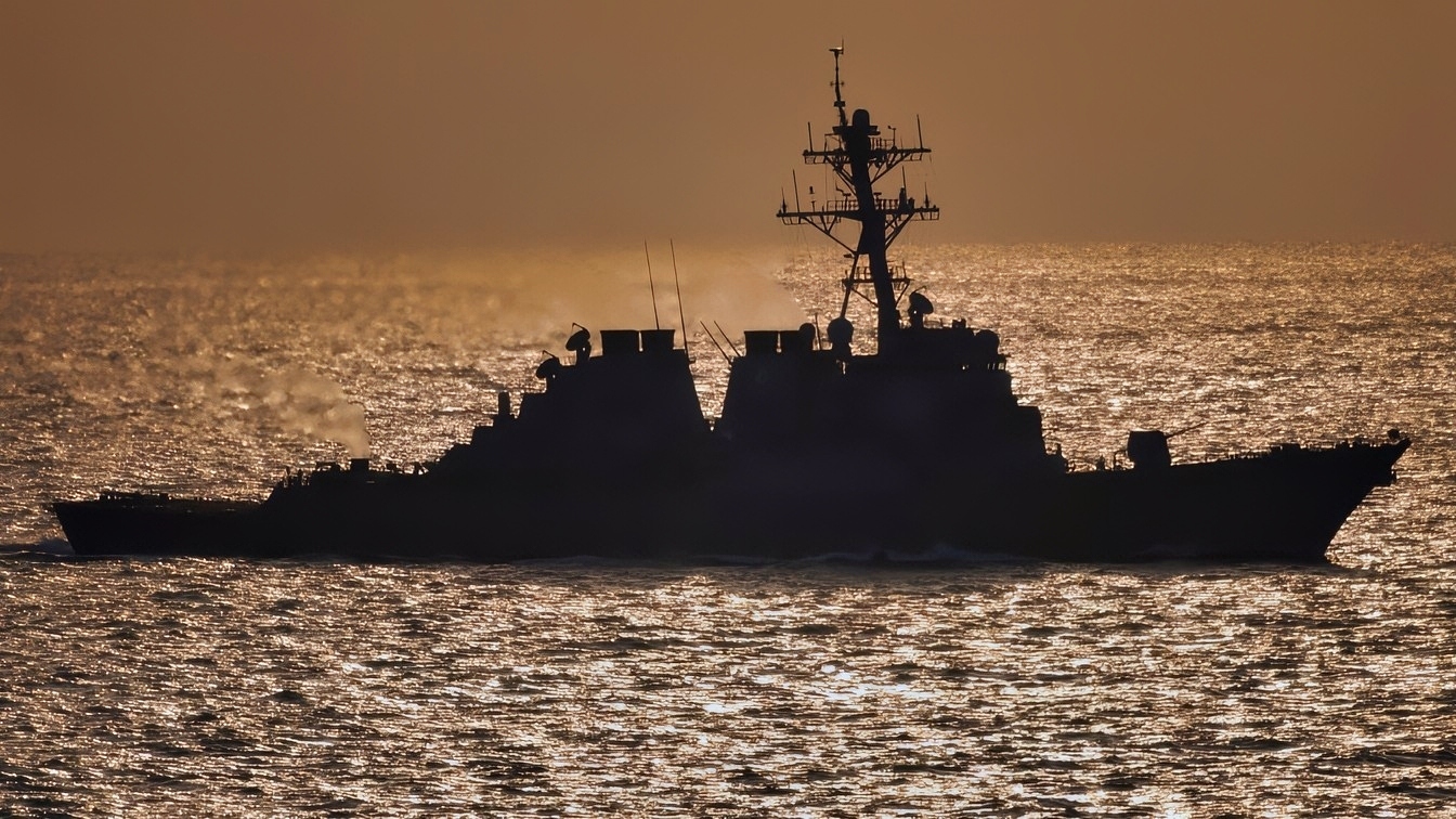 The guided-missile destroyer USS Donald Cook (DDG 75) steams behind the aircraft carrier USS Theodore Roosevelt (CVN 71) in the Persian Gulf on Jan. 31, 2006. The Roosevelt Carrier Strike Group is conducting maritime security operations in the Persian Gulf.