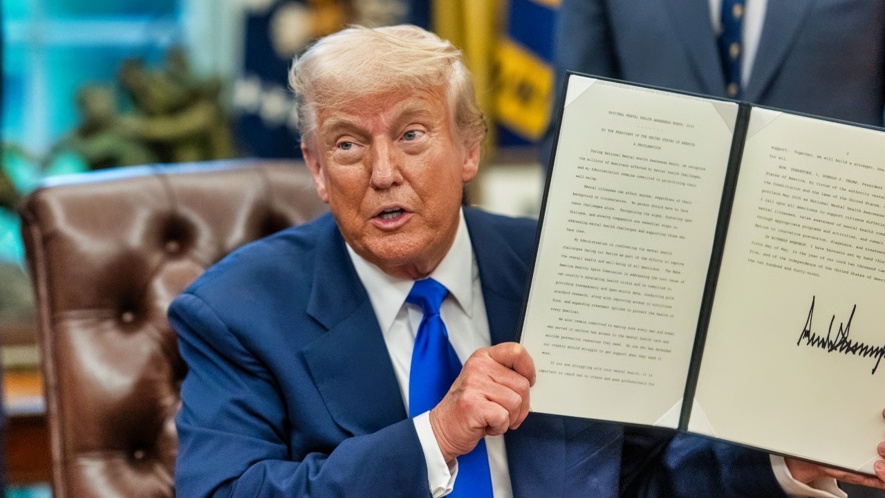 President Donald Trump signs executive orders flanked by Secretary of Health and Human Services Robert F. Kennedy, Jr. and Director of the National Institutes of Health Jay Bhattacharya, Monday, May 5, 2025, in the Oval Office. (Official White House Photo by Molly Riley)